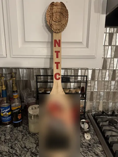 Instructor farewell paddle: Carved badge head, painted lettering and a printed photo panel for a training center instructor.