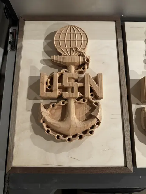 Chief's anchor shadow box: Fouled anchor and globe carved in relief, framed in walnut over birch.
